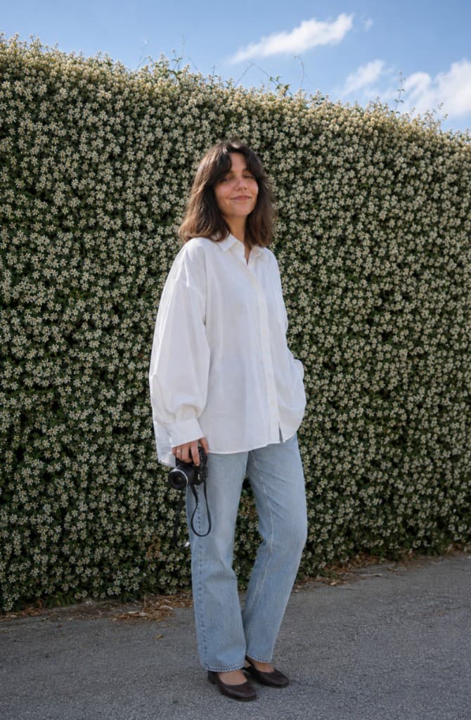 Stefani Dimitrova, founder of nau studio, holding a camera outdoors in Europe